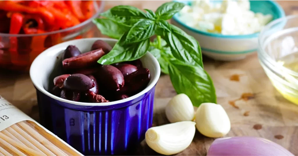 ingredients for Greek Pasta - Kalamata olives, garlic cloves, roasted red peppers, shallot, feta